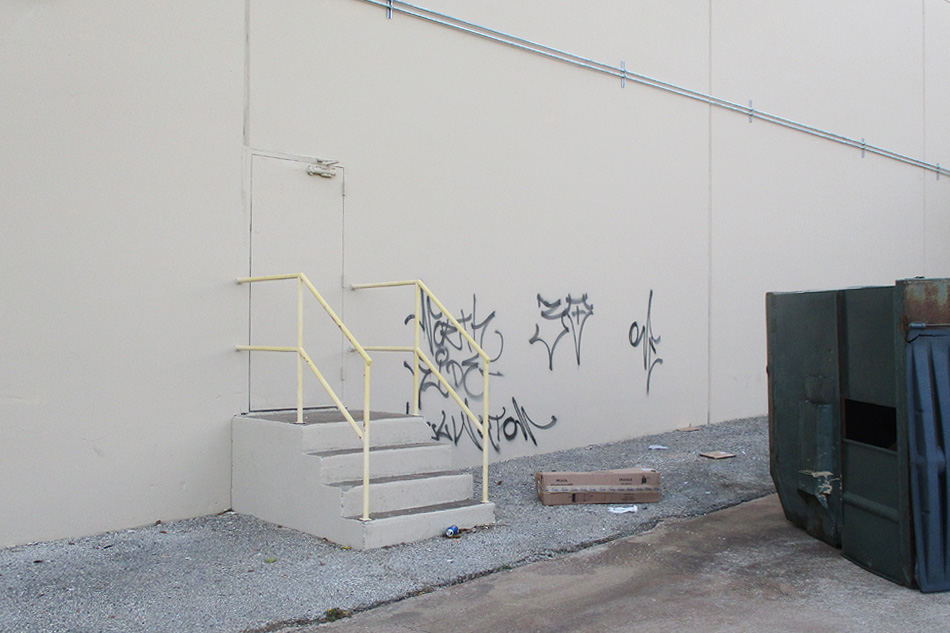 Before removing graffiti on alley