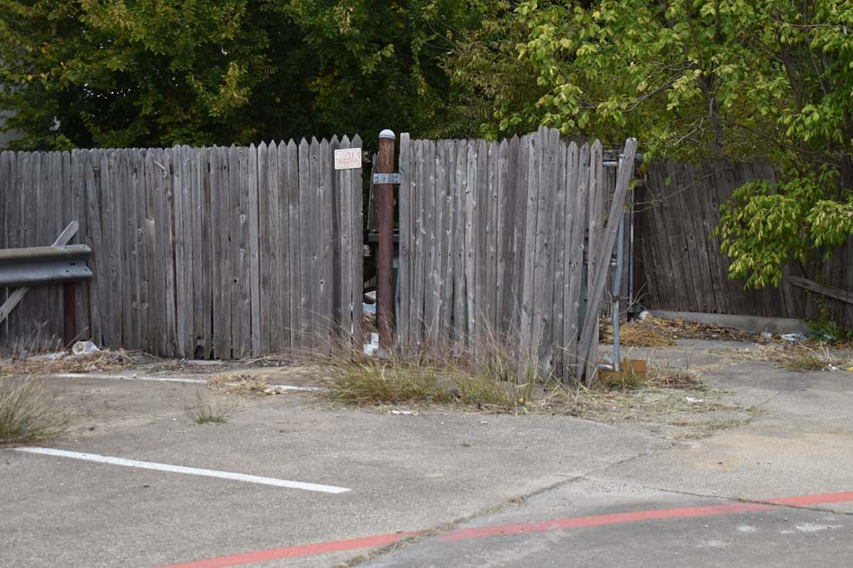 Image of a dilapidated fence missing pickets.
