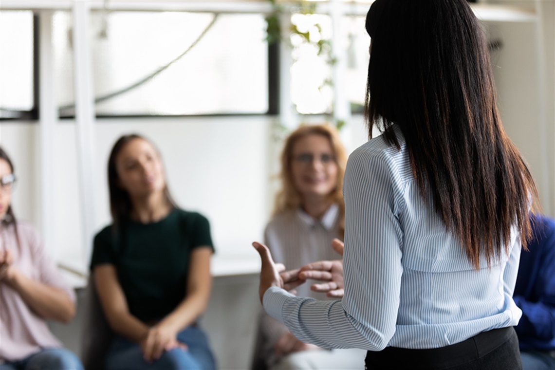 woman addressing business leaders at a workshop