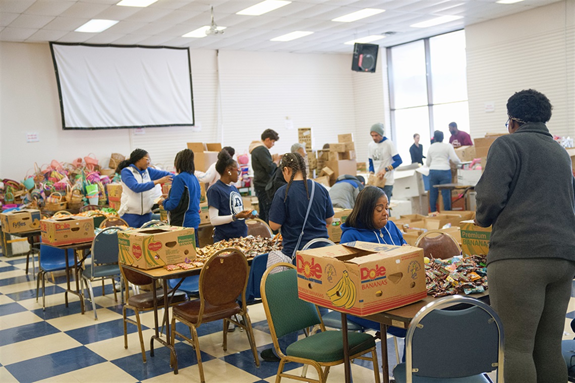 Volunteers collect and sort food items to provide to others. 