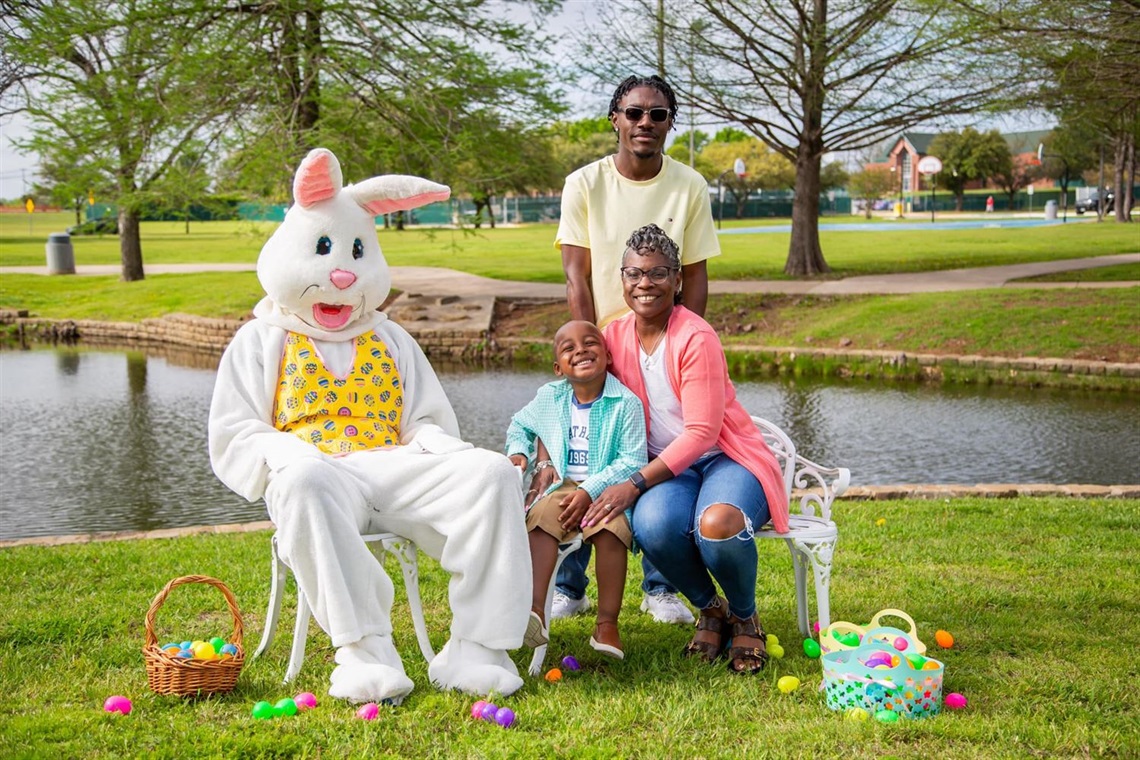 family photo in a park with a person in a bunny costume