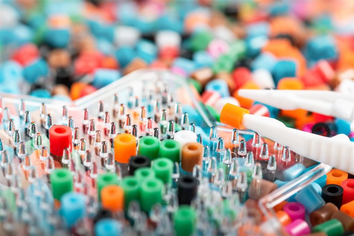 A close-up of a pegboard filled with colorful pegs.