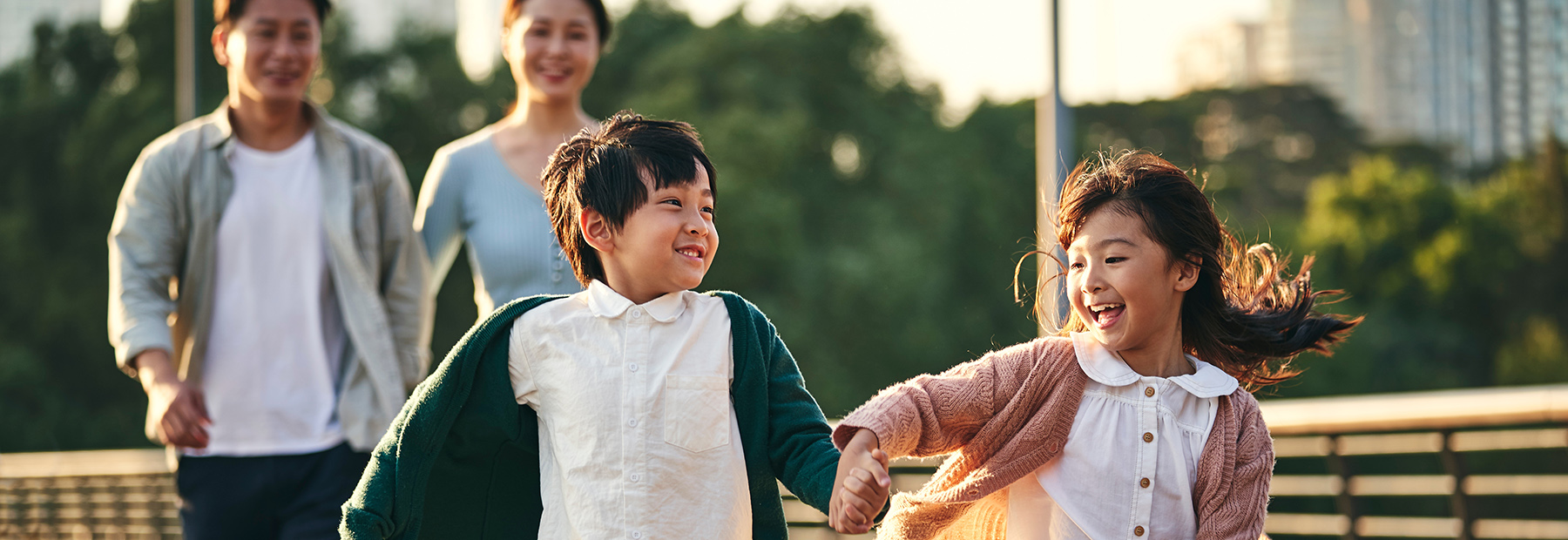 family walking outside with their two children.