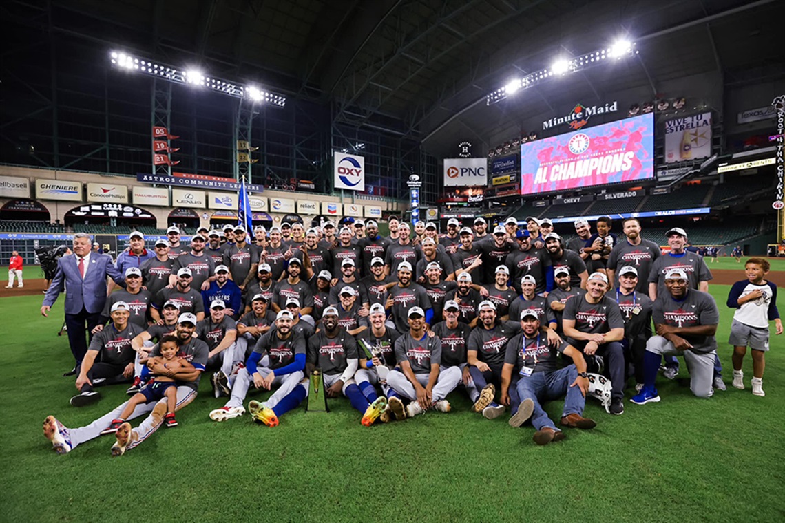 Members of the 2023 Texas Rangers baseball team pose for a photo at Minute Maid Park after winning the American League Pennant against the Houston Astros.