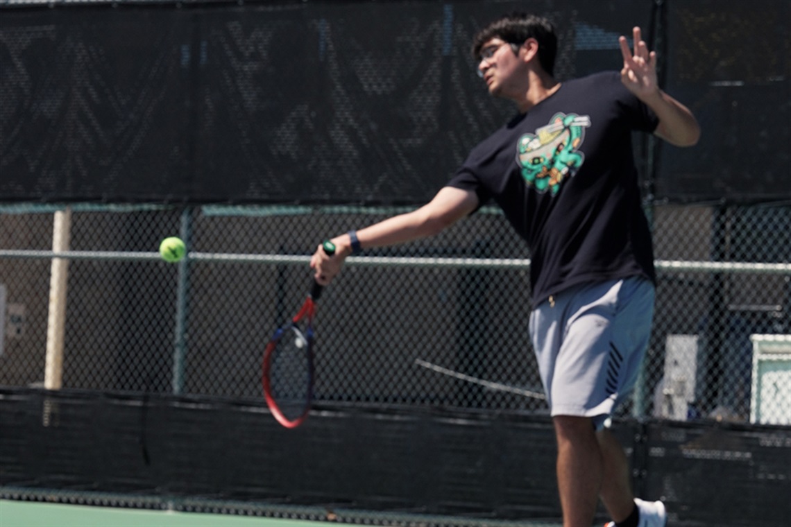 Matisse Matsumoto hits a tennis ball.