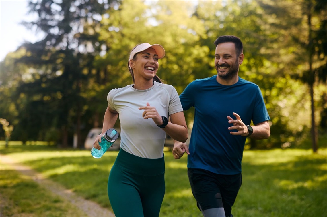 Man and woman jogging in park