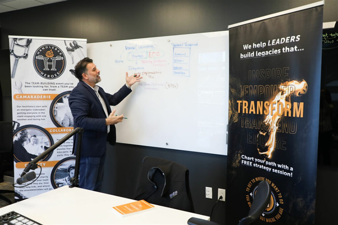 Michael Dailey at the whiteboard presenting.