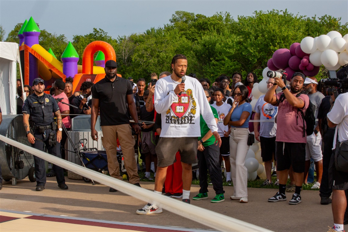 Cade Cunningham speaking into a microphone at basketball court grand opening event
