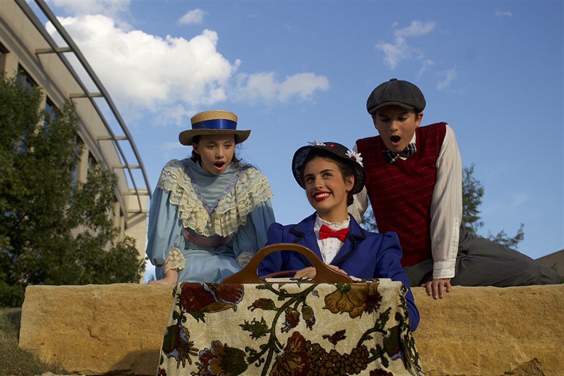 Actors with the production of Mary Poppins Jr pose for picture outside.