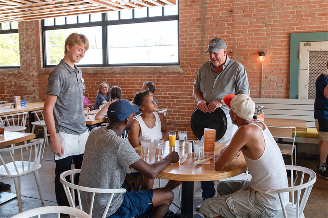 People being served at a restaurant table