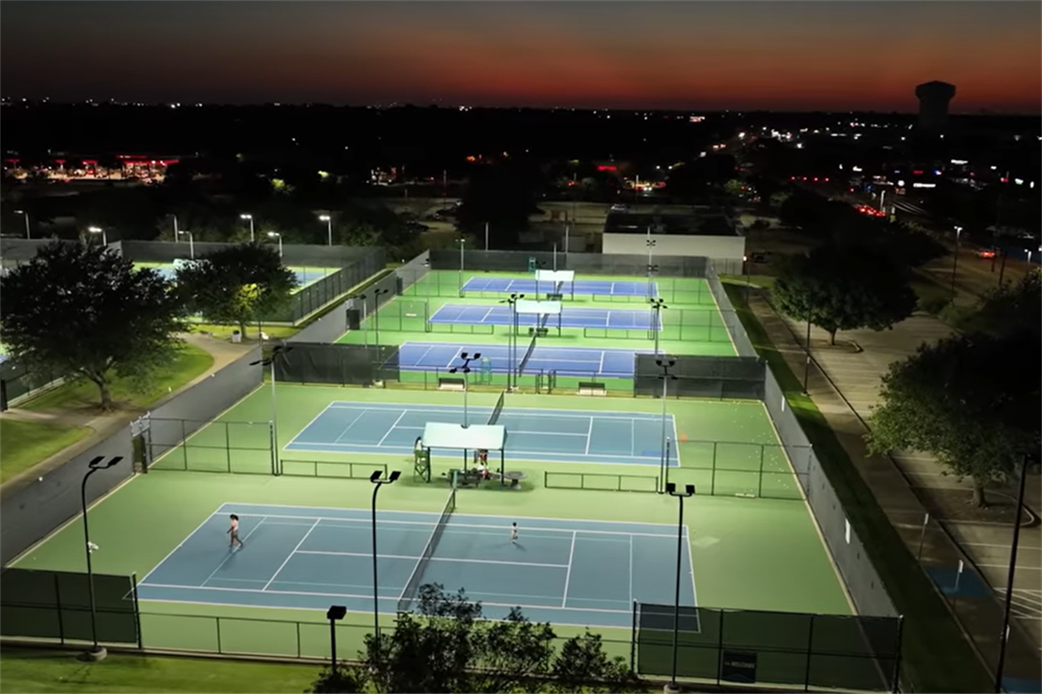 Arlington Tennis Center lit up at night