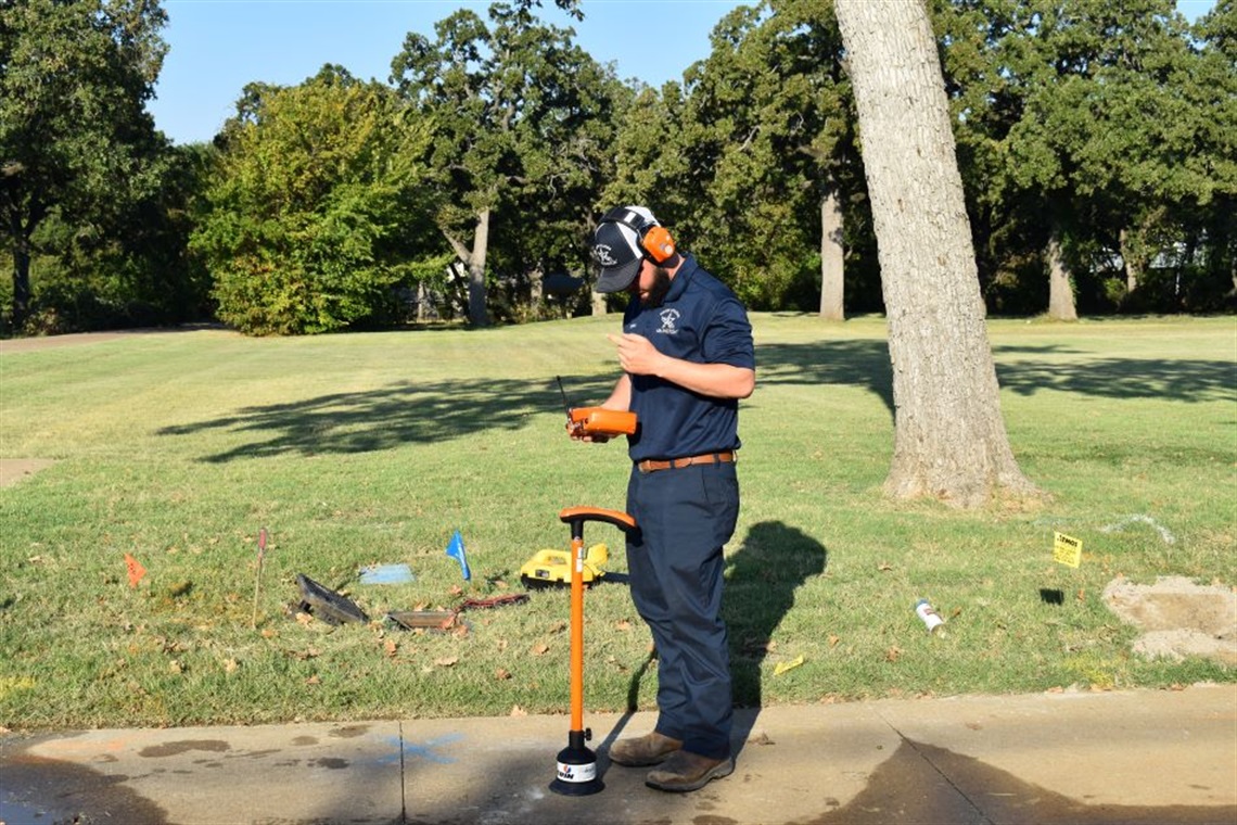 Water Utilities Worker using equipment to look for a water leak