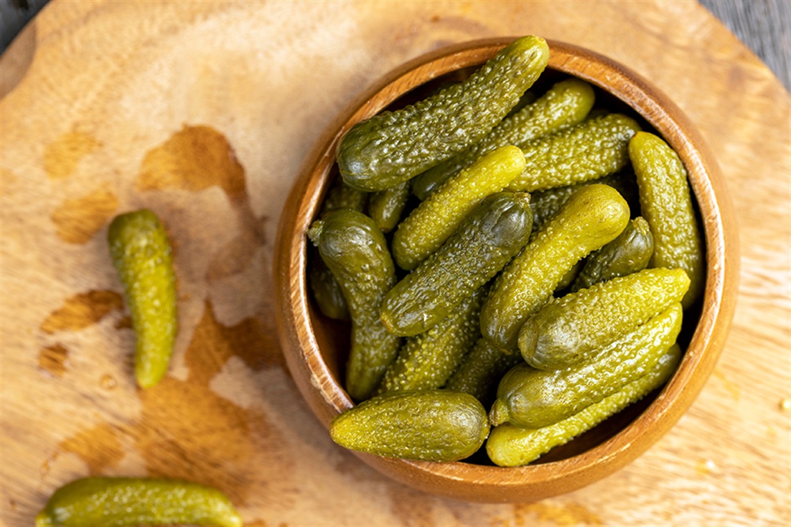 Green pickled cucumbers on the table, crispy salted pickled cucumbers of small size.