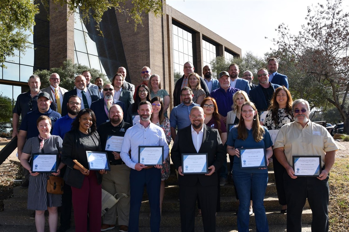 Group of people holding certificates