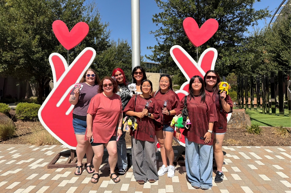 BTS ARMY fans taking a photo in front of the Finger Hearts photo op at City Center Plaza on Aug. 14, 2026