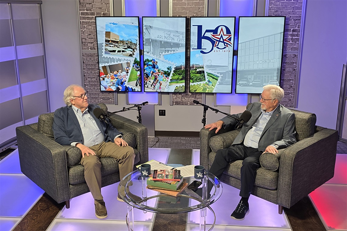 Arlington historian O.K. Carter and former Arlington mayor Richard Greene with microphones in front of them discussing history.
