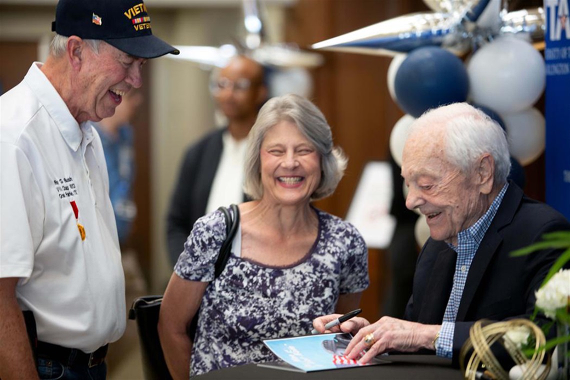 Journalist Bob Schieffer visits with members of the public at the grand opening of the 
