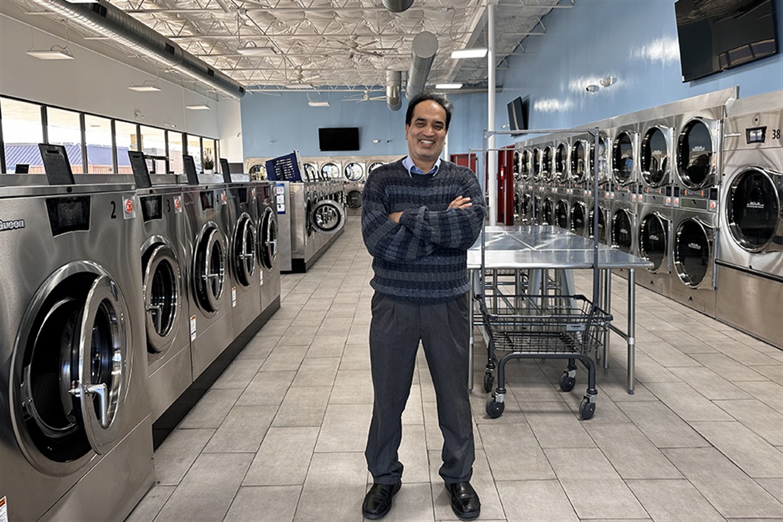 Owner of WashSmart standing in front of the washers