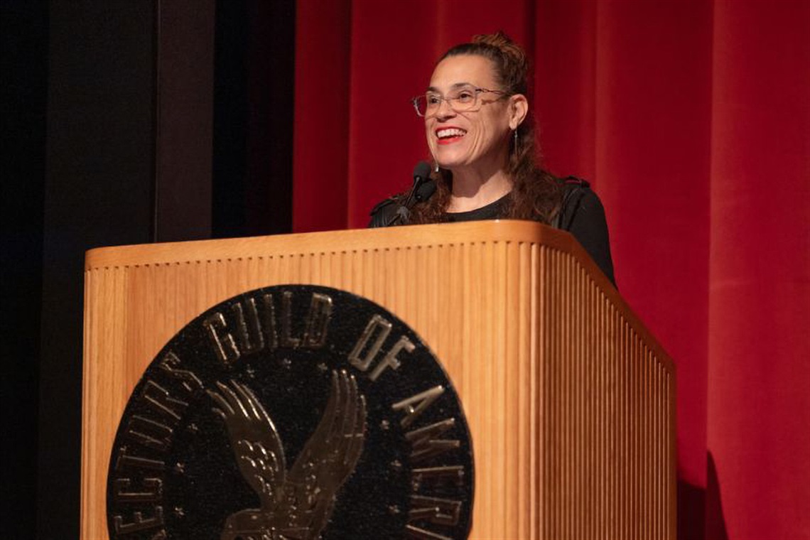 Dr. Rachel Raimist speaking from behind a podium.