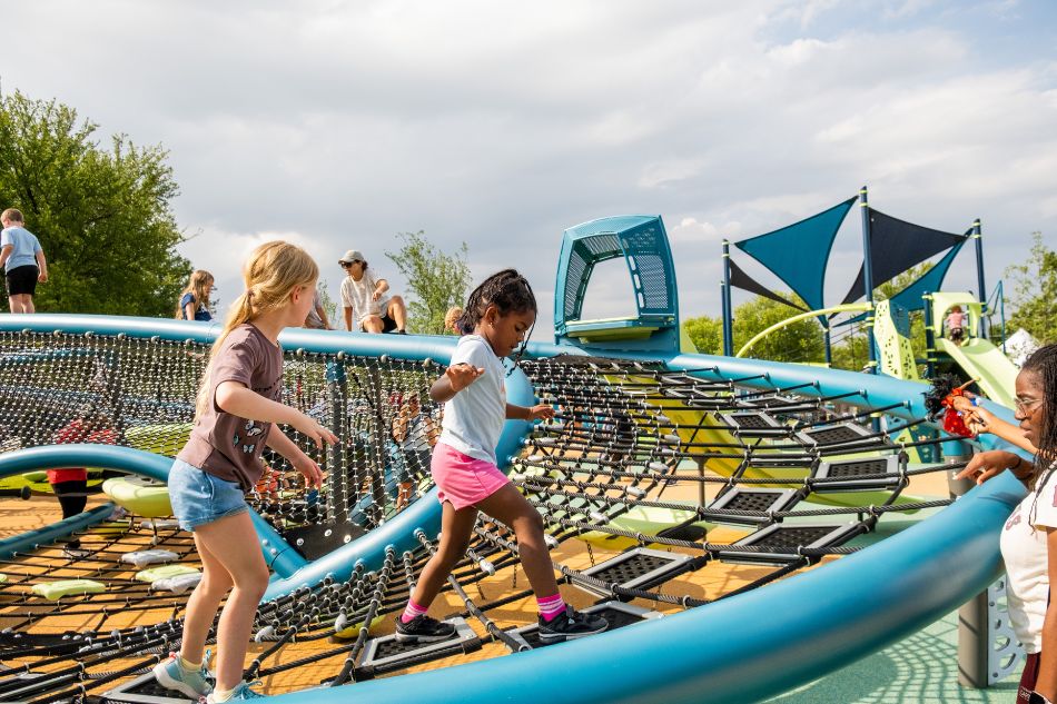 Children playing on playground at Al Rollins Park in June 2026.