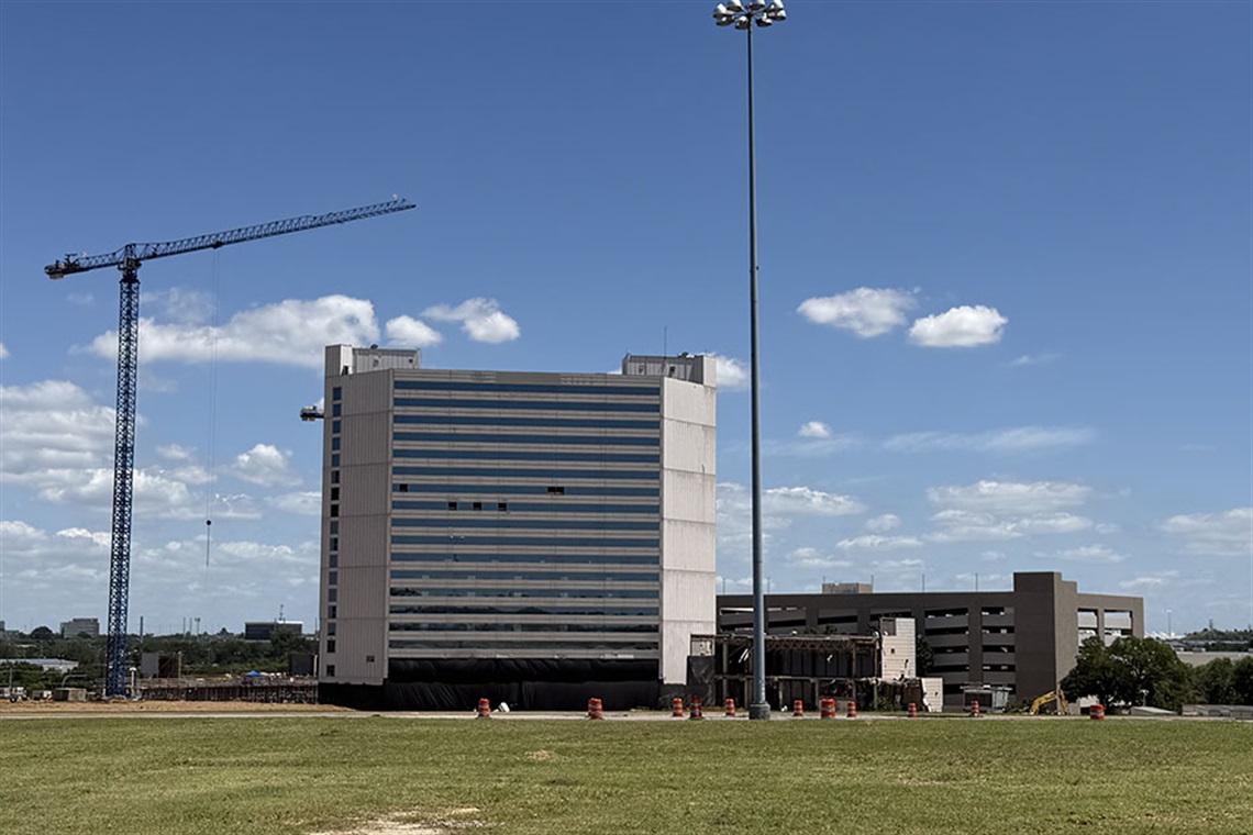Sheraton Arlington Hotel with a crane next to it.