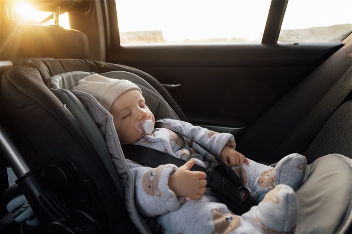Baby in a car seat inside of a car