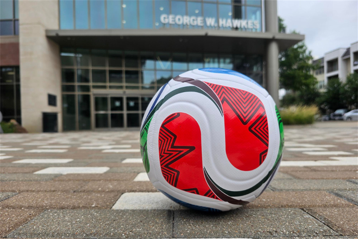 A soccer ball in front of the Library.png