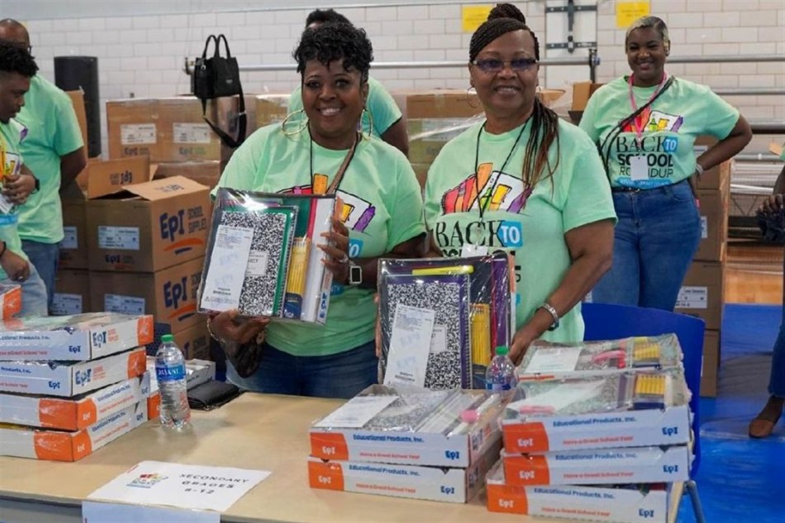 Volunteers with school supplies at the Tarrant County Back to School Roundup Event
