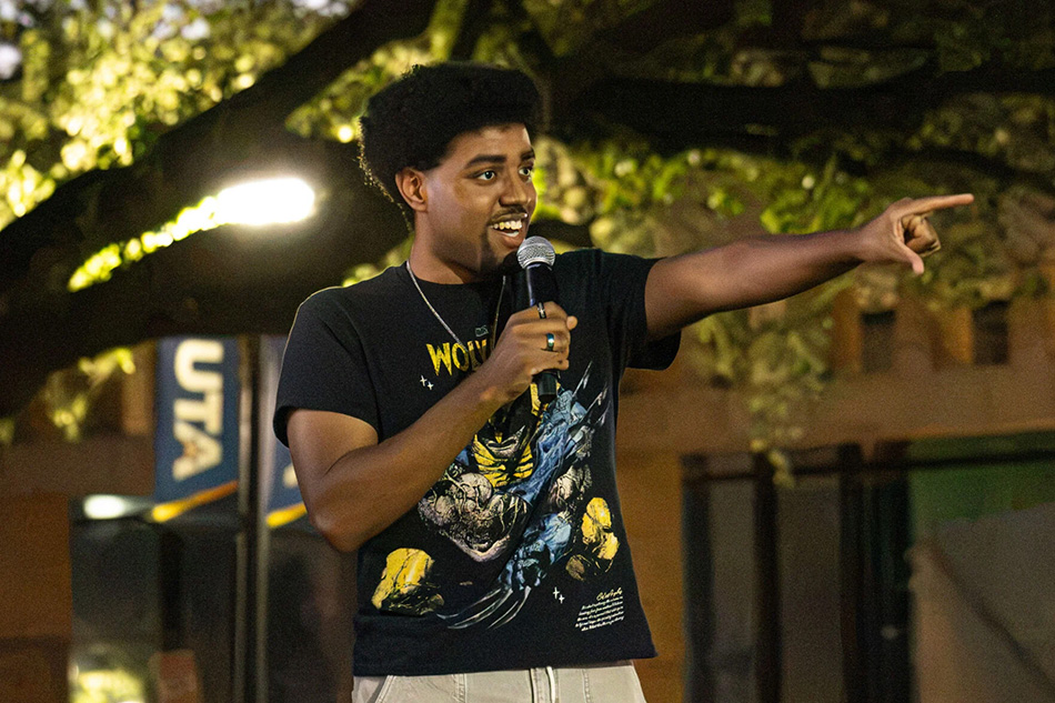 Victor Sanchez, Cinematic Art Mavericks president, speaks into a microphone during Mavs, Camera, Action event on Oct. 12 at Brazos Park. Over 10 films were submitted to the festival.