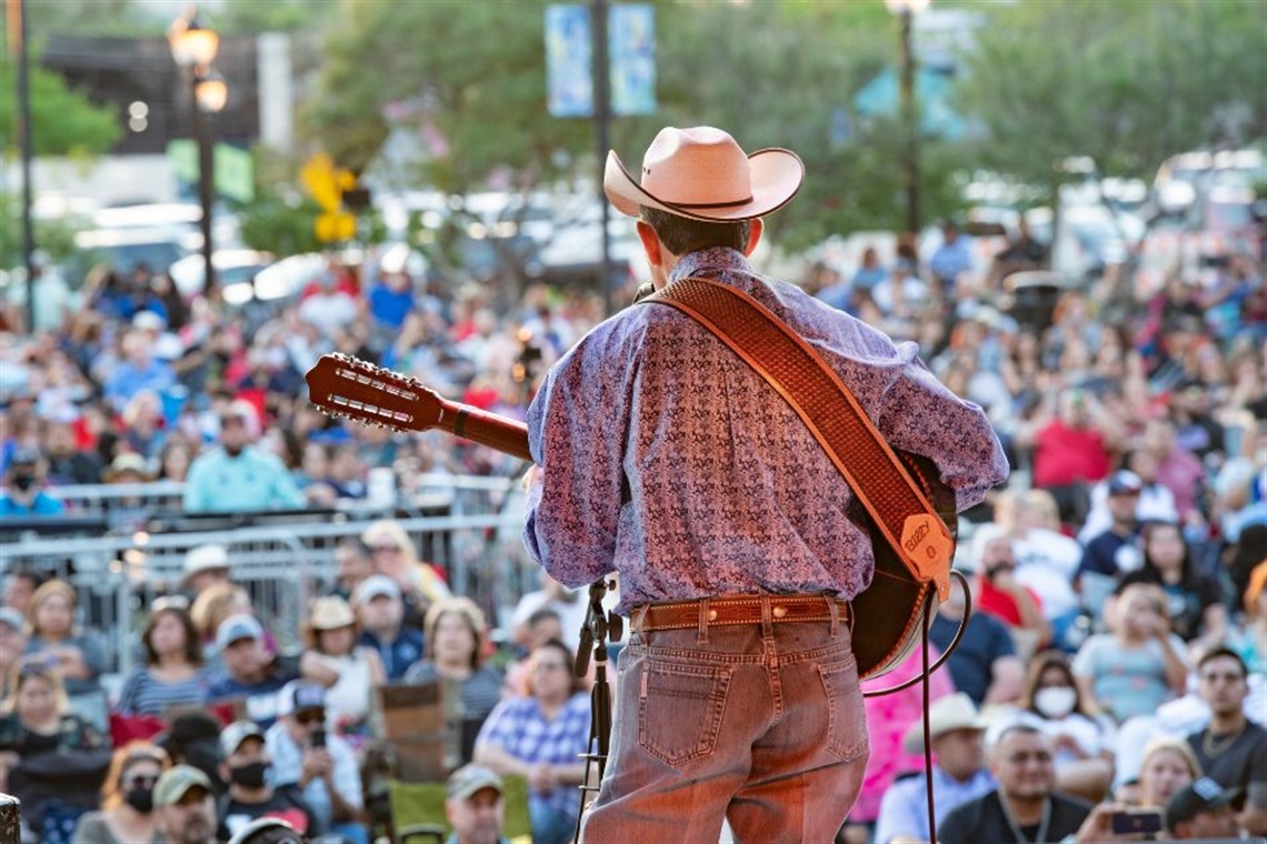 Guitarist in western hat playing a concert in front of crowd at Levitt Pavilion Arlington. Courtesy photo