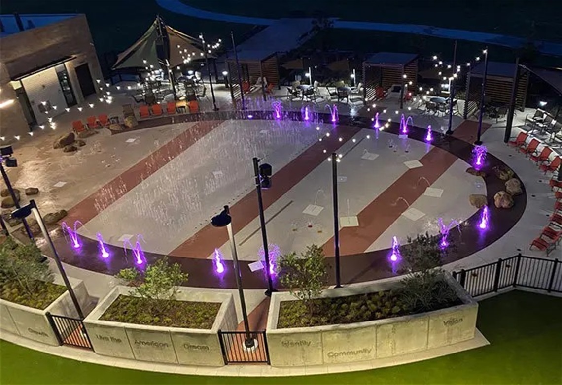 The Beacon Recreation Center's splash pad illuminated at night