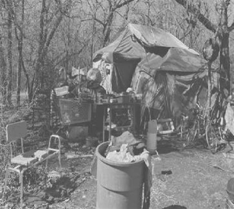 A black and white photo of a homeless encampment