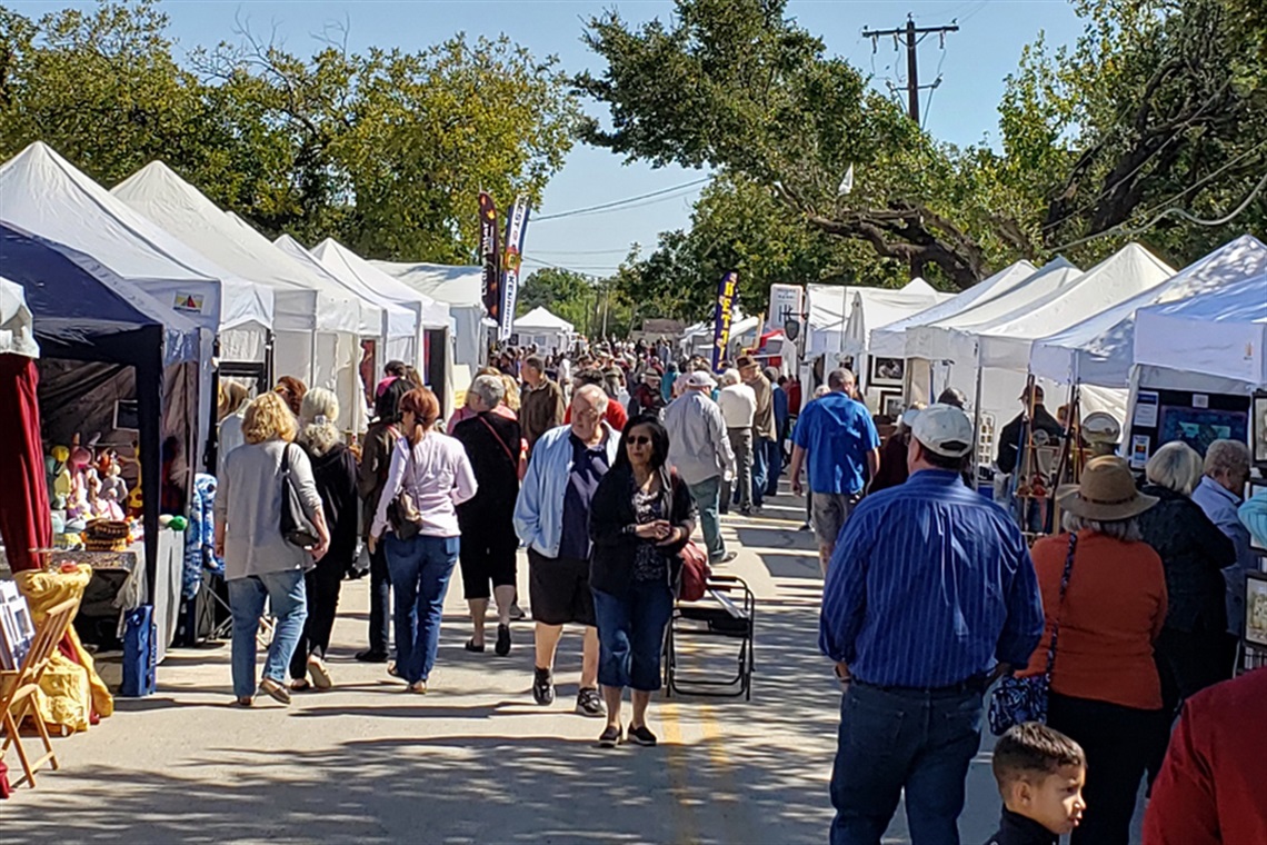People walking along South Street looking at vendors at the South Street Arts Festival in Arlington