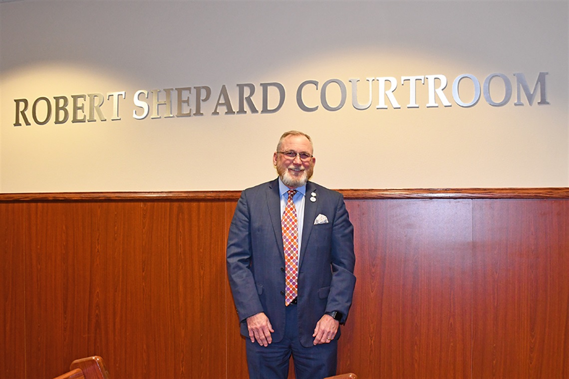 Former Councilmember Robert Shepard standing in the Robert Shepard Courtroom