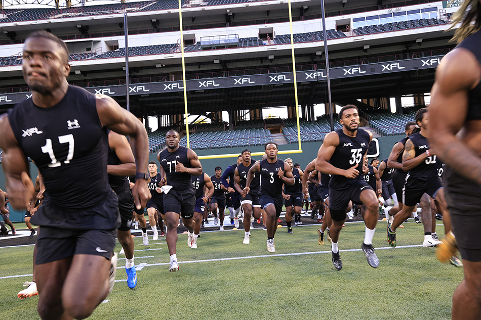 XFL players running onto the field at Choctaw Stadium