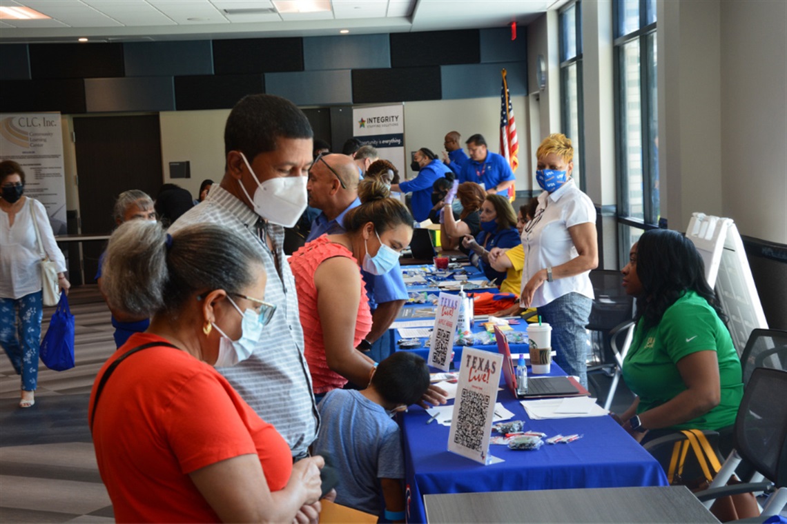 People at booths for the Arlington Public Library Job Fair
