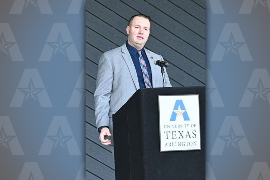 James Kumm makes remarks behind a lectern