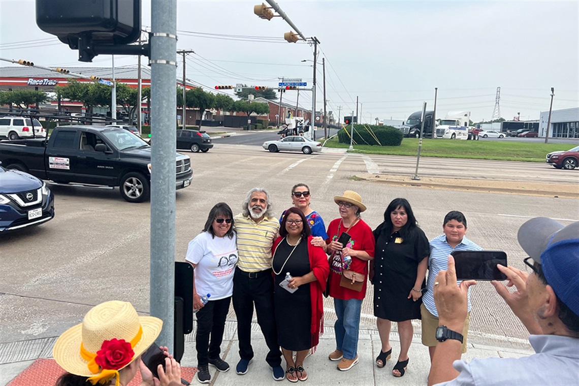 Group of people pose for photo at the Dolores Huerta Street Sign Topper Ceremony on May 27, 2023
