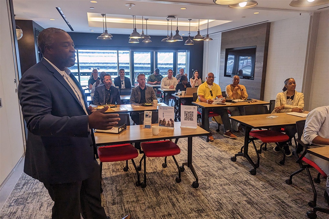 Capital Asset Advisors staff member talks to an audience 