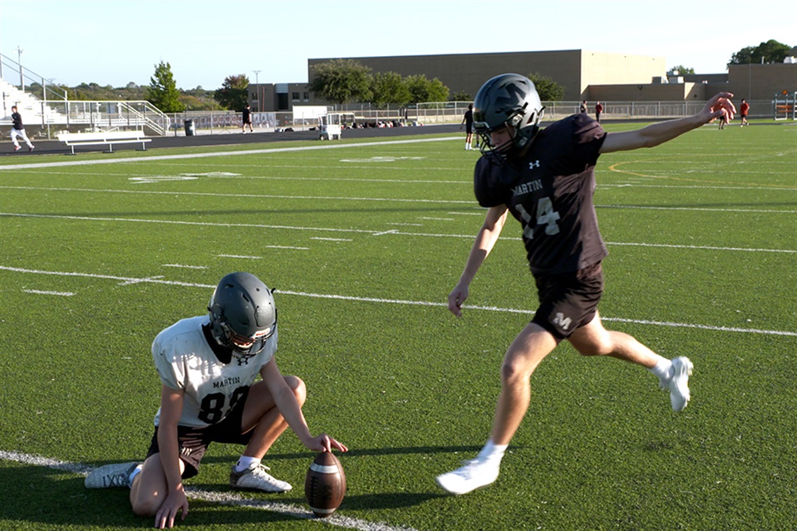 Harry Davidson kicking a football