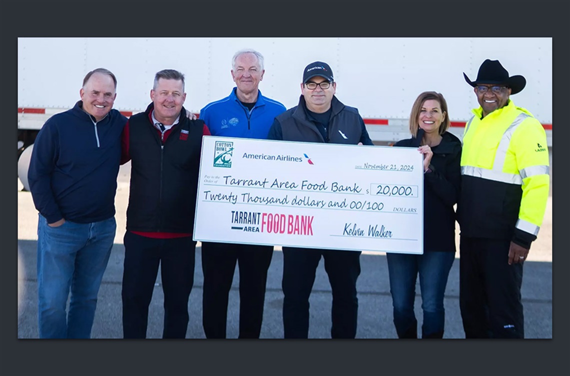 Members of several organizations holding large cardboard check for the Tarrant Area Food Bank.
