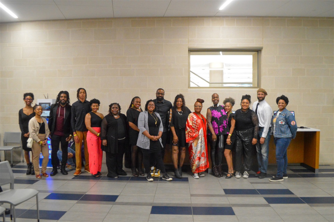 Group of people pose for photo in George W. Hawkes Downtown Library.