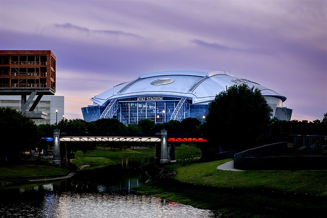 Kim Brimer Bridge at dusk with AT&T Stadium in the background