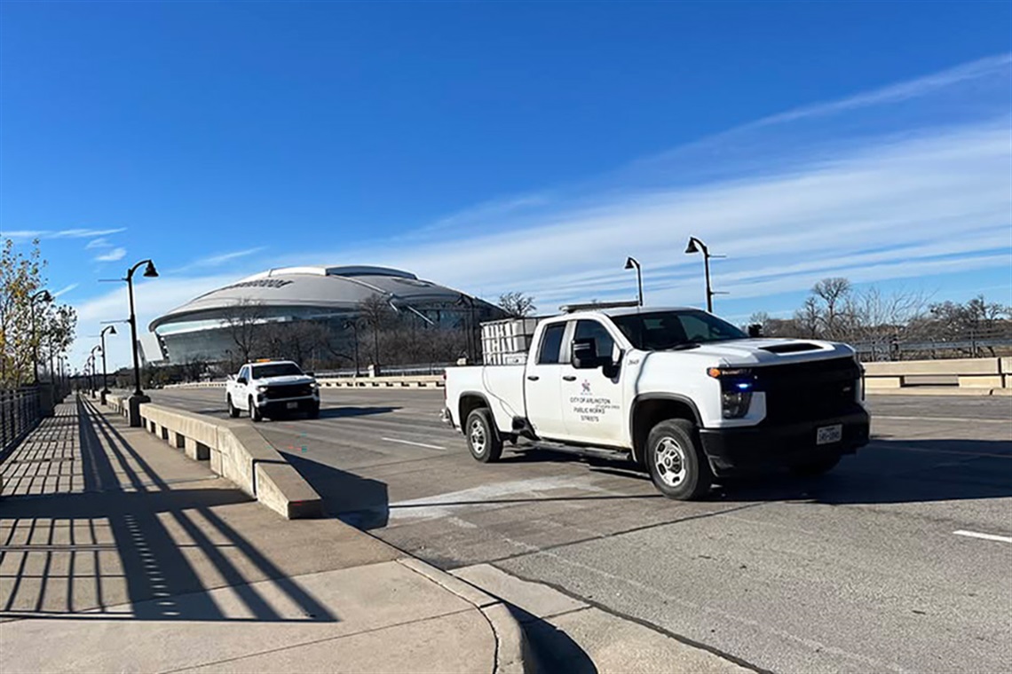 A City of Arlington Public Works vehicle treating a bridge crossing over Johnson Creek with a brine solution to prevent freezing in 2024.