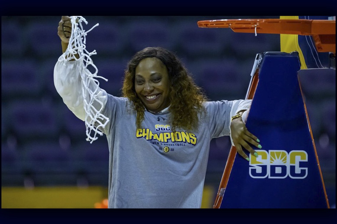 Shereka Wright cutting down the nets after conference championship win