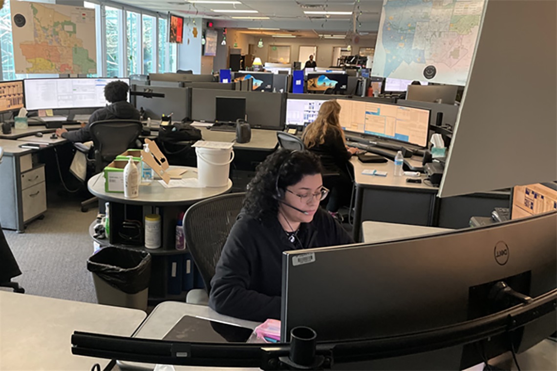 Dispatchers sitting near computer screens. 